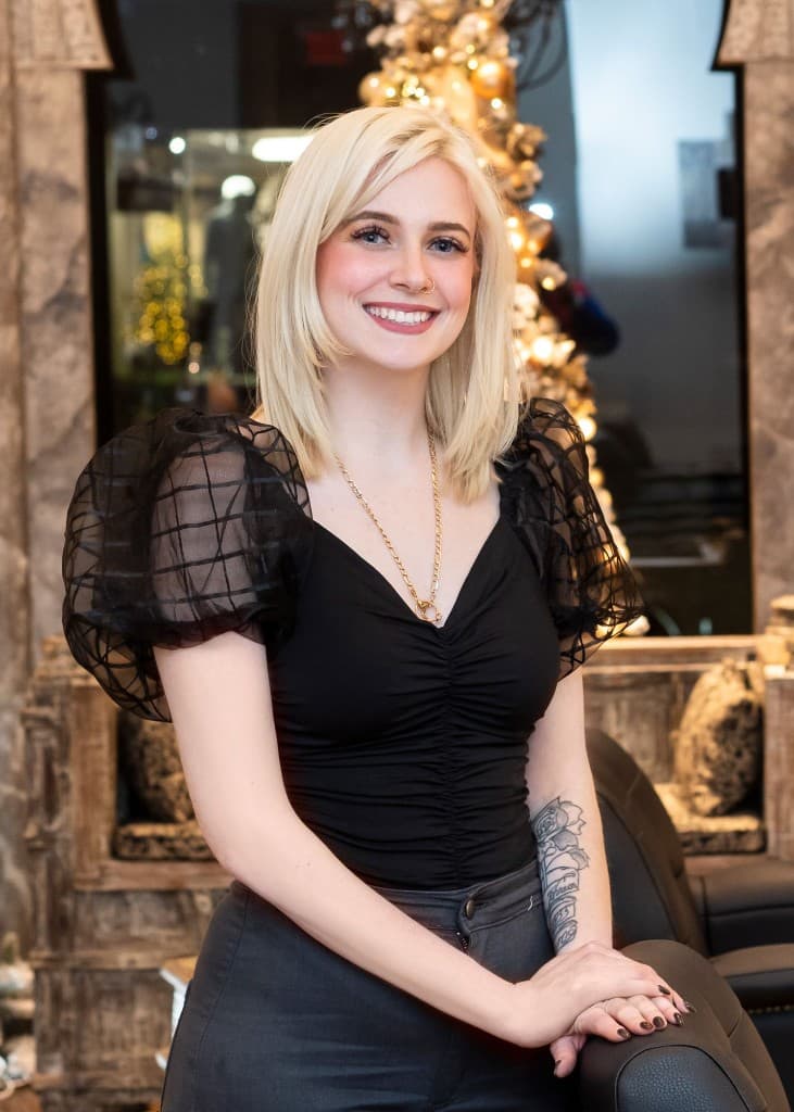 Portrait of Ashley smiling in a salon