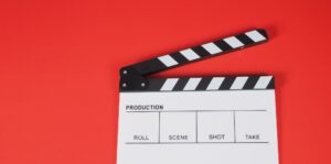 Clapperboard or movie slate. it use in video production ,film, cinema industry on red background.