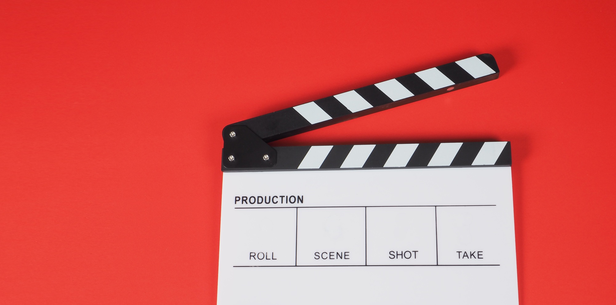 Clapperboard or movie slate. it use in video production ,film, cinema industry on red background.