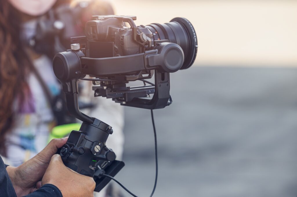 Motorized Gimbal, people using digital camera with anti shake for video production scene stabilizer